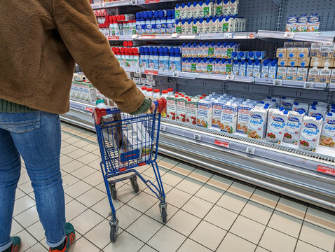 France, 16 March 2024: Consumer Shopping for Dairy Products in Supermarket.