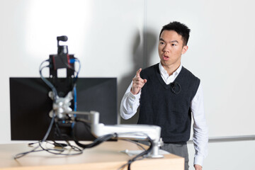 Fototapeta premium Young tutor teaching in front of the camera for an online class