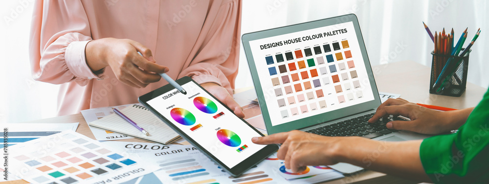 Poster a cropped picture of professional designer selects the color by using color theory while using lapto