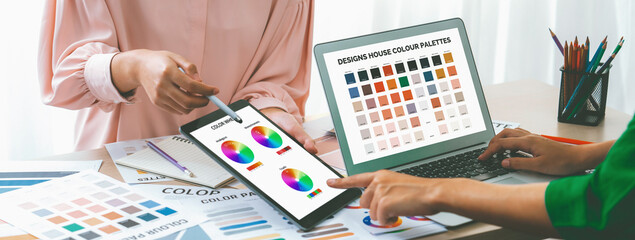 A cropped picture of professional designer selects the color by using color theory while using...