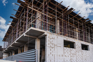 A building under construction with scaffolding and formwork for the 3rd floor.