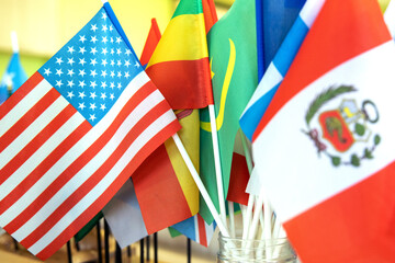 Close-up on the flags of Peru and the USA against the background of other flags of the world.
