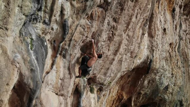 Climber climbing a hard and steep section of the wall and taking a huge fall at Kalymnos island, Greece. High quality 4k footage.