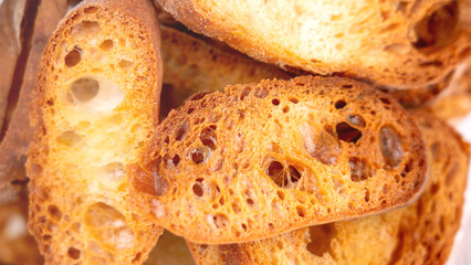Close-up of baguette croutons, Toasts, bruschetta from sliced baguette, close up view, Toasted baguette slices isolated on white background close up. Toast, crouton. Top view.