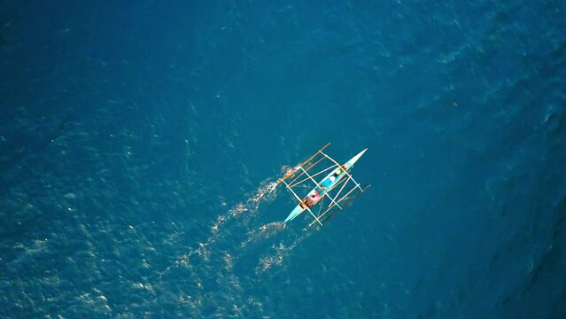 Aerial: Drone Panning Shot Of People In Outrigger Moving On Wavy Sea During Vacation - Palawan, Philippines