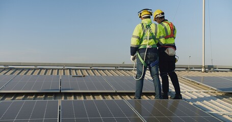 Technicians engineer in safety vests and helmets discussing analysis maintenance install solar...