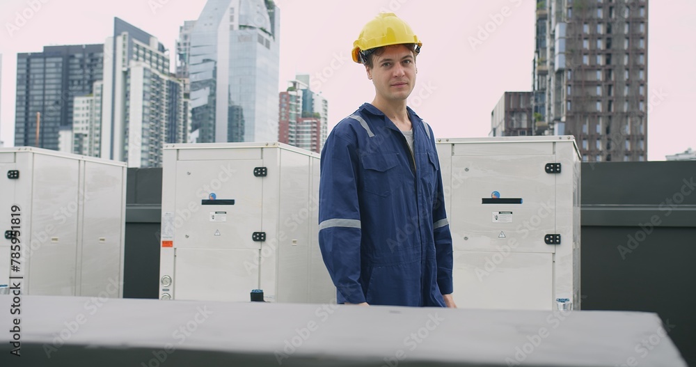 Wall mural engineer man in a blue jacket is walking inspecting maintenance insulated pipelines valve pump contr