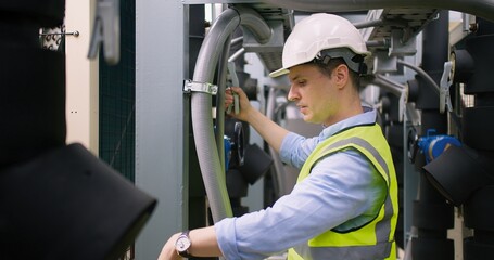 Civil engineer manager checking industry cooling air conditioner water cooling tower air chiller of...