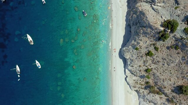 Aerial: Top down orbit drone shot of Lalaria beach in Skiathos island, Sporades, Greece with turquoise  crystal cleat water