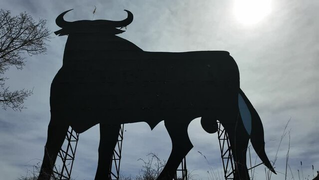 Extreme closeup view of a Spanish black bull abandoned billboard. Timelapse. Sunny, blue sky with some high clouds. 4K