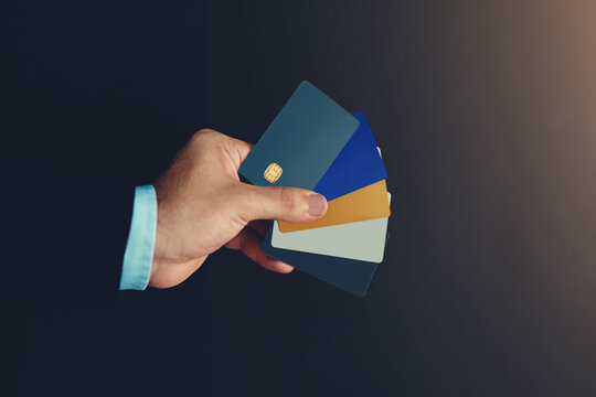 Businessman, hand and credit card in studio for wireless transaction, credit score and accounting. Financial advisor, payment and e commerce on dark background for payment authorisation and sales