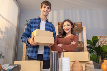 Confident Vase Sellers Proudly Displaying The Products in a Cozy Workshop