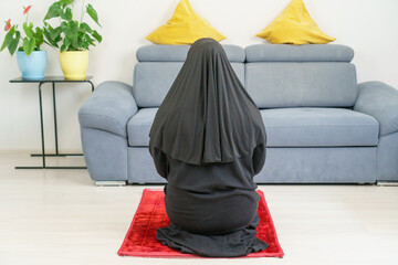 Adult woman do player for god in Islamic traditional, portrait of girl pray on mat at home with copy space