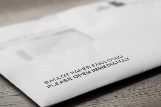 Ballot paper postal vote letter for the Local Elections in England. On a wood table top