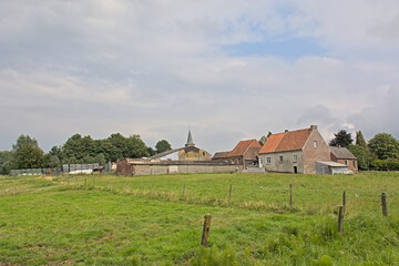 Old traditional farm and meadow in the village of Dikkele, Flanders, Belgium 