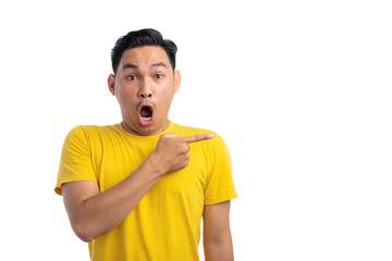 Shocked young Asian man pointing finger at empty copy space isolated on white background. Advertising and presentation concept