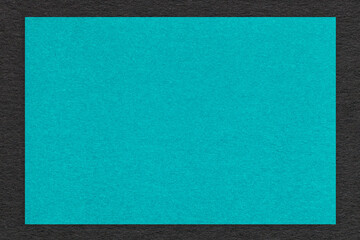 Texture of craft turquoise color paper background with black border, macro. Vintage cerulean...