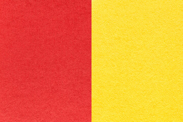 Texture of craft red and yellow paper background, half two colors, macro. Vintage dense cardboard.