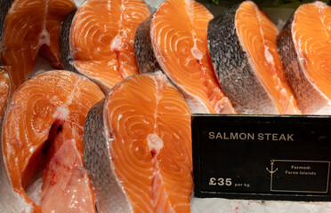 Organic wild Scottish red fish salmon steaks cleaned on ice on Portobello road Saturday market in...