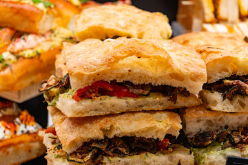 Fresh baked focaccia buns filled with eggs and truffles ready to eat in food hall, London, Covent Garden market