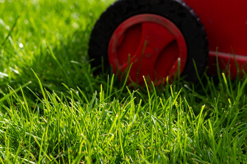 Seasonal maintenance works in garden, lawn movers in action, green grass cutting, lawn care, English lawn - 785973872