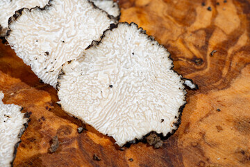 Slices of Italian black summer truffle, tasty aromatic mushroom, close up