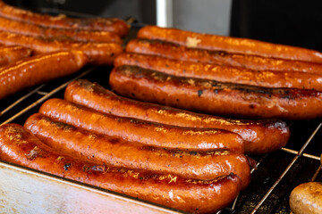 German street food on Portobello road Saturday food market, London, Uk, many BBQ grilled sausages ready to eat in outdoor café