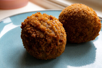 Traditional street food in UK, stuffed fried Scotch eggs with breadcrumbs close up