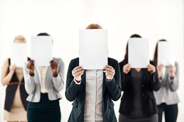 Businesswoman, staff and holding message on board in studio for anonymous interview of career. Professional, group and female people with blank paper hiding face for marketing as brand ambassador