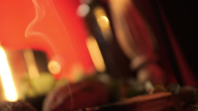 Palo santo aroma stick and its smoke on a decorated table