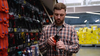 Electric drill for construction in hand man in store