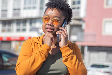 urban black woman with phone on the street