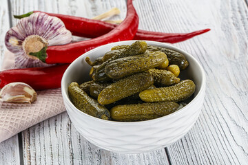 Marinated small cucumbers in the bowl