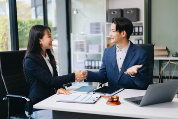 Judge and client shaking hands and lawyers discussing contract papers after adviced in background at courtroom, lawyer service.