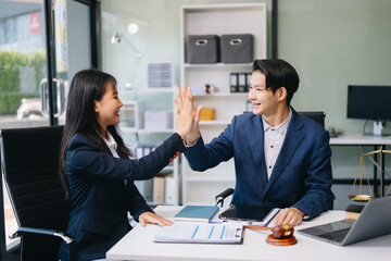 Judge and client shaking hands and lawyers discussing contract papers after adviced in background at courtroom, lawyer service.