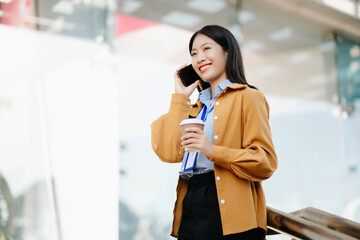 Young Asian business woman leader entrepreneur, professional manager holding digital tablet computer uon the street in big city