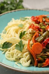 Vegetarian meal. Tasty pasta with vegetables on table, closeup