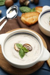 Fresh homemade mushroom soup served on blue wooden table