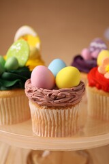Tasty cupcakes with Easter decor on stand, closeup
