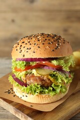 Burger with delicious patty on wooden table