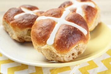 Tasty hot cross buns on table, closeup
