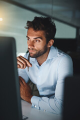 Serious, thinking and businessman with pen by computer for email, internet and working late in office for corporate career. Happiness, desk and lawyer with technology for communication in workspace