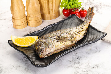 Baked Dorado fish served lemon