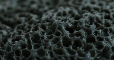 Ultra Close-Up of a Highly Porous Stone Surface. Dolly shot, shallow dof.