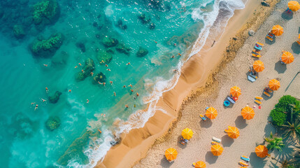 Overhead shot capturing a vibrant beach scene with multiple orange umbrellas, swimmers in turquoise waters, and lush greenery. Ideal for travel and vacation themes. - 786014633