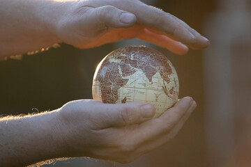 Hand holding a world globe. Earth Day environment concept.