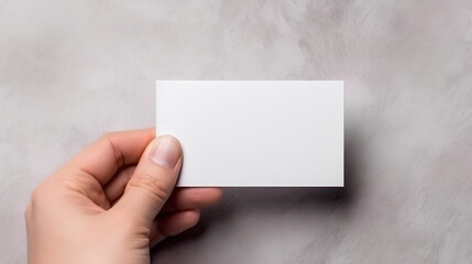 A blank sheet of paper in the hands of a person.