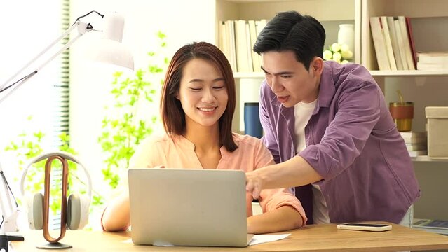 Two young Asian businesspeople working