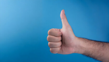 Thumb up hand gesture on blue background. Approval, success and agree communication gesture.