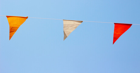 Party flags on a rope, blue background